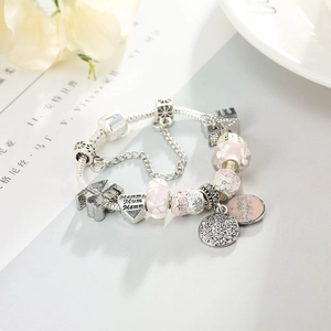 Silver charm bracelet with pink glass beads, heart pendants and Eiffel Tower charm