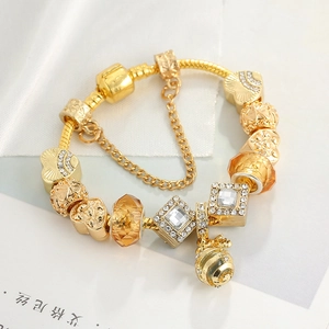 Elegant gold-plated snake chain bracelet featuring honeycomb charms and crystal heart beads