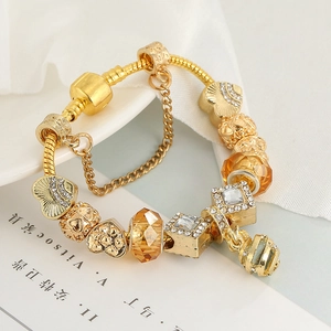 Elegant gold honeycomb charm bracelet with amber glass beads and safety chain on a plate