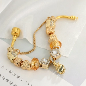 Golden bee honeycomb charm bracelet with heart beads and amber glass on a snake chain