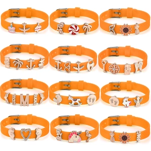 Adjustable orange silicone strap bracelets with assorted alloy charms and buckle closure