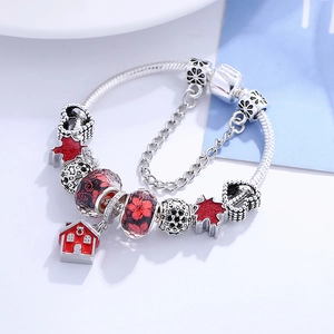 Silver snake chain bracelet with red maple leaf charms and house pendant