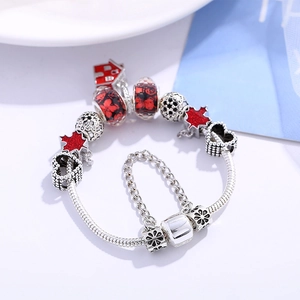 Silver snake chain bracelet with red house pendant and maple leaf glass charms