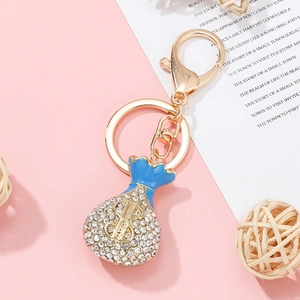 Golden money bag keychain with blue enamel and sparkling rhinestones for bags