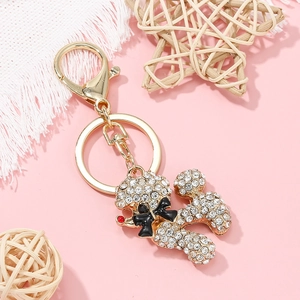 Close-up of sparkling rhinestone poodle keychain with golden alloy finish and lobster clasp