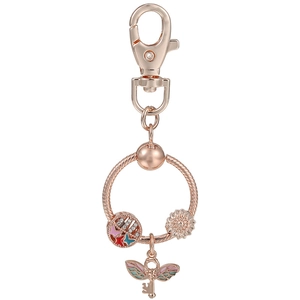 Rose gold DIY keychain with butterfly, sunflower charm and winged key pendant on white background