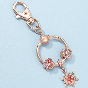 Rose gold keychain with sparkling leaf, snowflake charms and pink zircon inlays