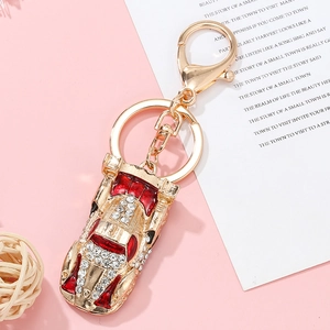 Luxury gold metal car keychain with red enamel and sparkling rhinestones for handbags