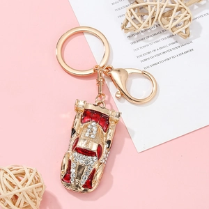 Sparkling crystal encrusted sports car keychain with red enamel accents and gold hardware