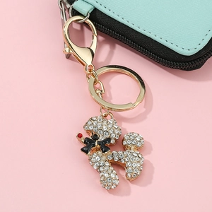 Sparkling crystal dachshund keychain on blue wallet with gold lobster clasp accessory
