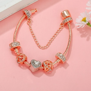 Elegant rose gold snake chain bracelet with pink rhinestone heart and crown charms