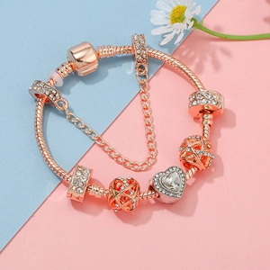 Rose gold crown charm bracelet with pink crystal heart and sparkling safety chain