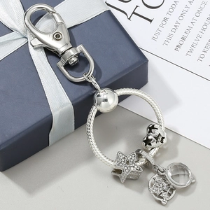 Porte-clés argenté avec pendentifs étoile et cœur sertis de pierres sur coffret cadeau