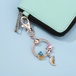 Unicorn and rainbow pendant keychain set with rose gold ring on mint green pouch