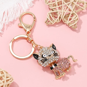 Porte-clés chat scintillant avec strass blancs et roses sur métal doré brillant