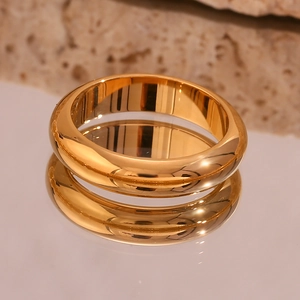 Macro shot of thick 18K gold-plated stainless steel ring with polished mirror finish