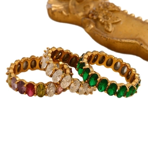 Three-piece gold eternity rings set with oval-cut white, green, and multi-color zircons