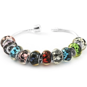 DIY colorful glass bead charm bracelet with silver snake chain and floral patterns