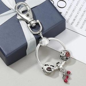Silver DIY keychain with snake chain heart pendant and red lip bead on gift box