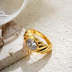 Macro detail of 18K gold plated ribbed ring with a large sparkling round zircon stone