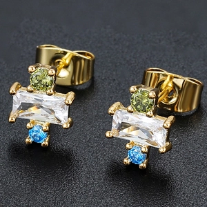 Macro shot of 18K gold earrings with tricolor square zircons and butterfly backs
