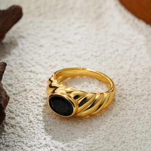 Macro shot of 18K gold plated vintage ring featuring a central oval black gemstone