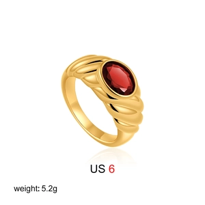 Detail view of vintage 18K gold ring with oval red gemstone and ribbed band design