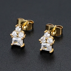 Macro detail of 18K gold plated square zircon stud earrings with butterfly backs