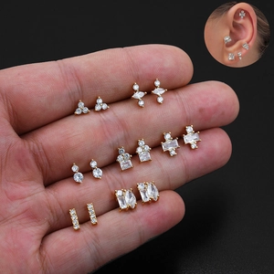 Detailed view of various 18K gold-plated stud earrings with cubic zirconia on black background