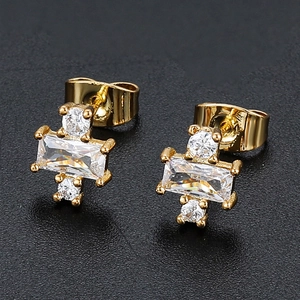 Macro shot of 18K gold studs featuring rectangular zircons with symmetric star accents