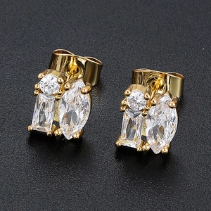 Macro detail of 18K gold earrings with mixed-cut cubic zirconia and secure butterfly backs