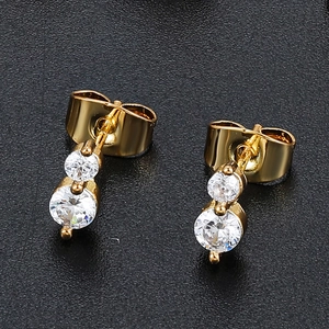 Macro shot of 18K gold plated double clear zircon drop earrings with butterfly backing