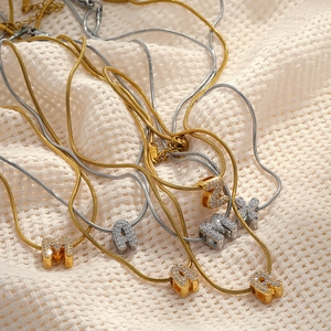 Gold and silver snake chain necklaces with 18K gold plated CZ pavé letter pendants