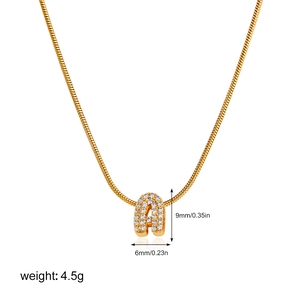 Detailed view of gold snake chain with zircon pavé letter A pendant measuring 9mm by 6mm