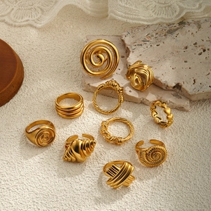 Set of 9 vintage 18K gold plated spiral shell rings for women in elegant arrangement