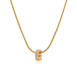 Detail of 18K gold letter E pendant with cubic zirconia on a sleek snake bone chain