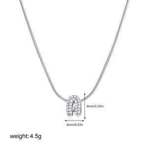 Macro detail of 18K gold letter A pendant with cubic zirconia and dimensions