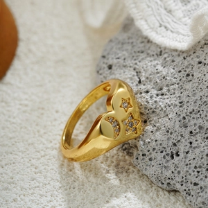 Detail of 18K gold plated heart ring featuring zircon inlaid star and moon motifs