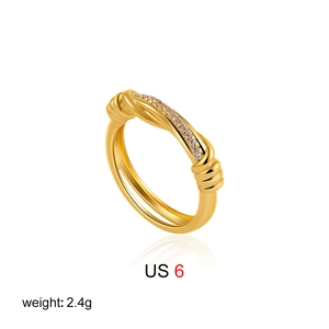 Macro detail of 18K gold knot ring with cubic zirconia stones showing US size 6 2.4g weight