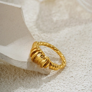 18K gold plated croissant dome ring with twisted textured design on a natural stone surface