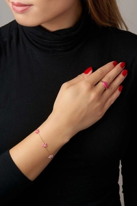 Detail of 18K gold plated bracelet with pink flowers and matching lip-shaped ring
