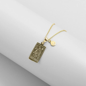 Detail of gold Sagittarius tarot pendant necklace with intricate zodiac engraving and fine chain