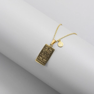 Macro shot of gold Leo zodiac rectangular pendant and charm on stainless steel chain