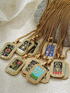 Detailed close-up of The Star tarot card pendant with blue enamel and gold finish