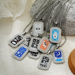Detail of tarot card pendants with colorful enamel patterns and sparkling zircon borders