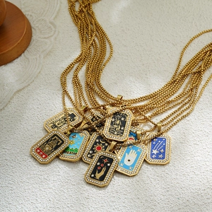 Detail of gold tarot card pendant necklaces with colorful enamel patterns and zircon borders