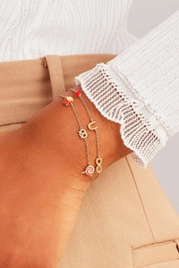 Detail of 18K gold double-layer chain bracelet with colorful enamel dopamine charms