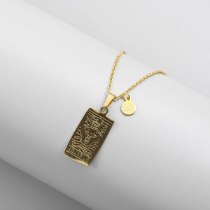 Macro detail of gold-plated Aquarius pendant necklace with engraved square and round charms