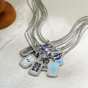 Detail of tarot card pendants with rhinestone borders and colorful enamel mystical symbols