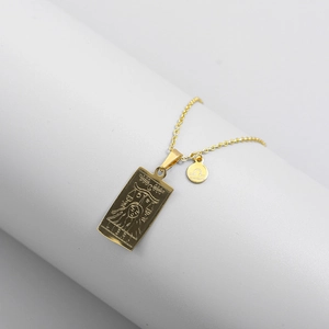 Detailed macro view of gold Libra zodiac rectangular tarot pendant and small round charm